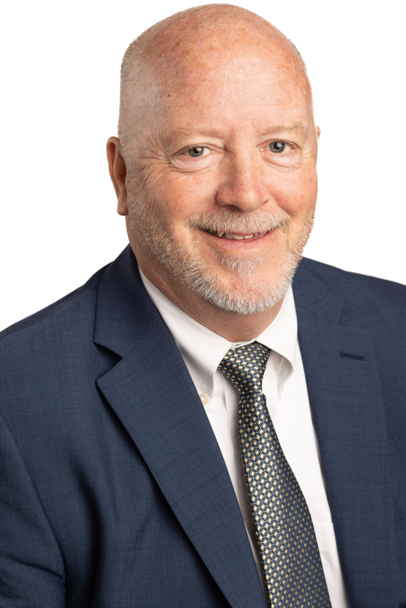 Gerry C. Schmelter, partner at DMAB law firm, smiling in a professional suit and patterned tie, representing legal expertise in business and real estate law.