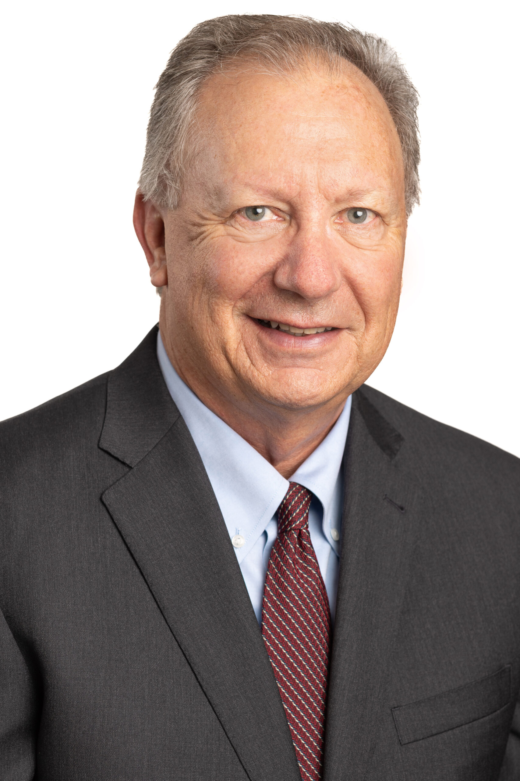 Headshot of a professional male attorney in a gray suit and maroon tie, representing the legal team at Dillon, Miller, Ahuja & Boss, LLP in Carlsbad, CA.