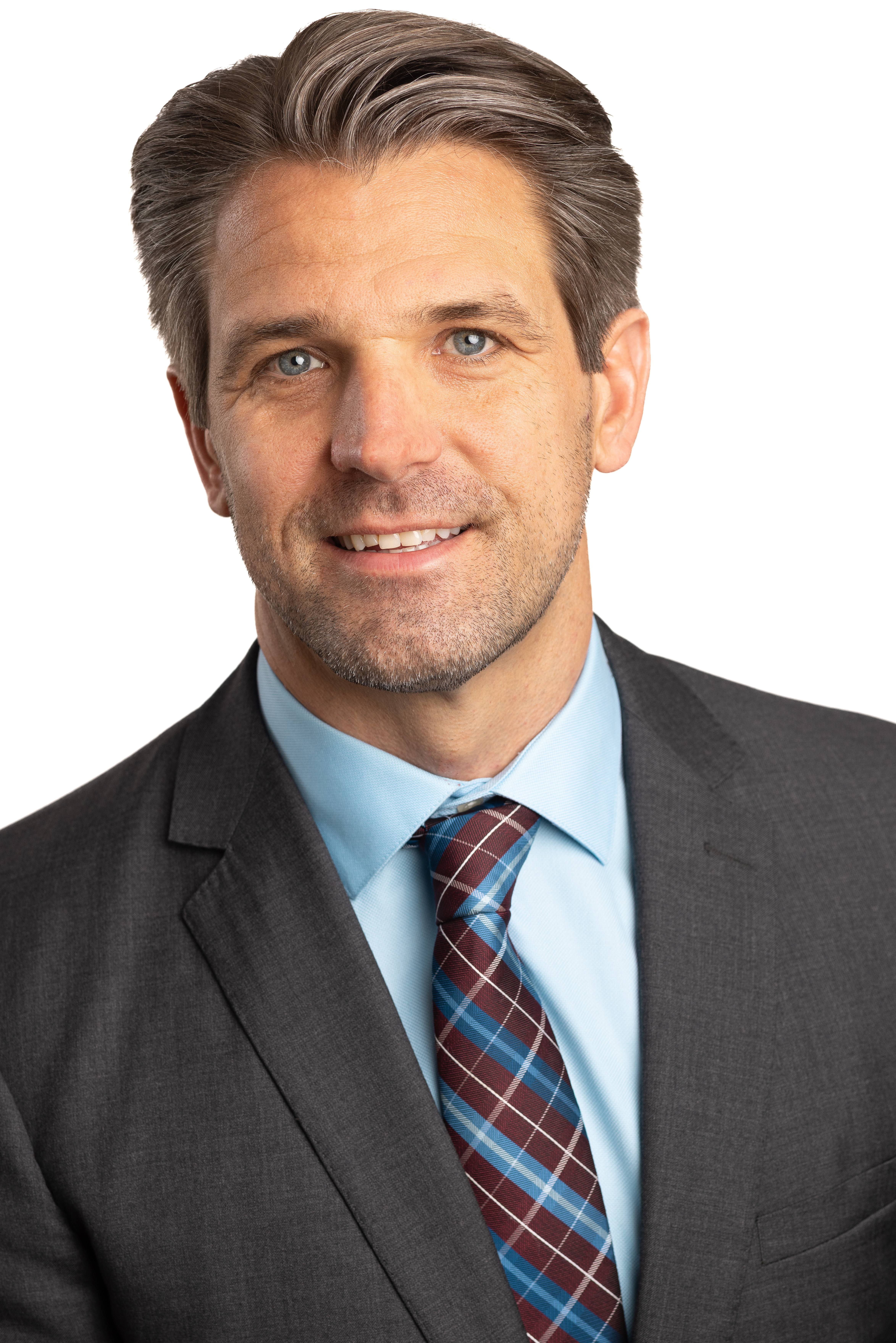 Kevin A. Kachman, attorney at Dillon, Miller, Ahuja & Boss, LLP, wearing a gray suit and plaid tie, smiling against a white background.