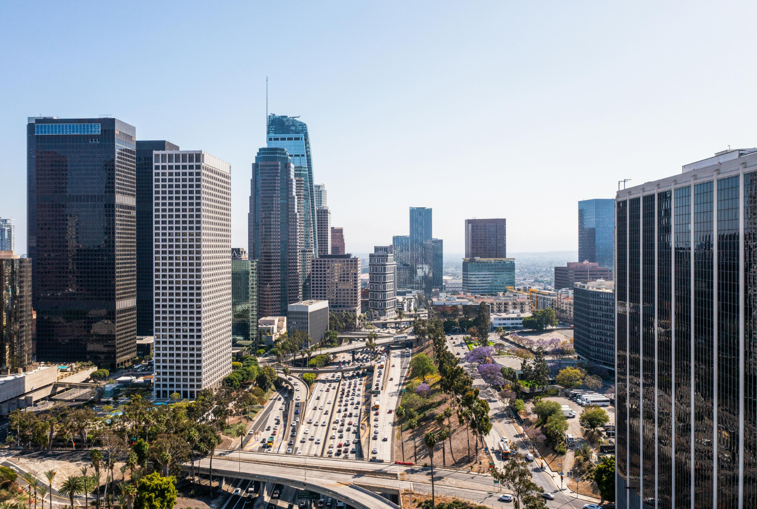 Aerial view of downtown Los Angeles featuring modern skyscrapers, busy highways, and urban landscape, relevant to California LLC formation and business services.