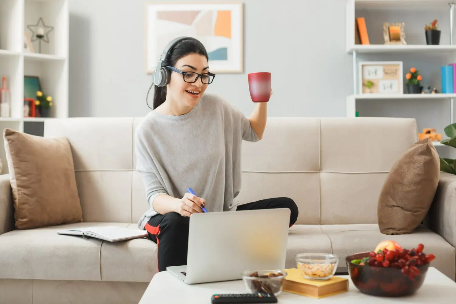 Person working on a laptop from a home living room, representing a home-based business or remote professional setup in Carlsbad, California