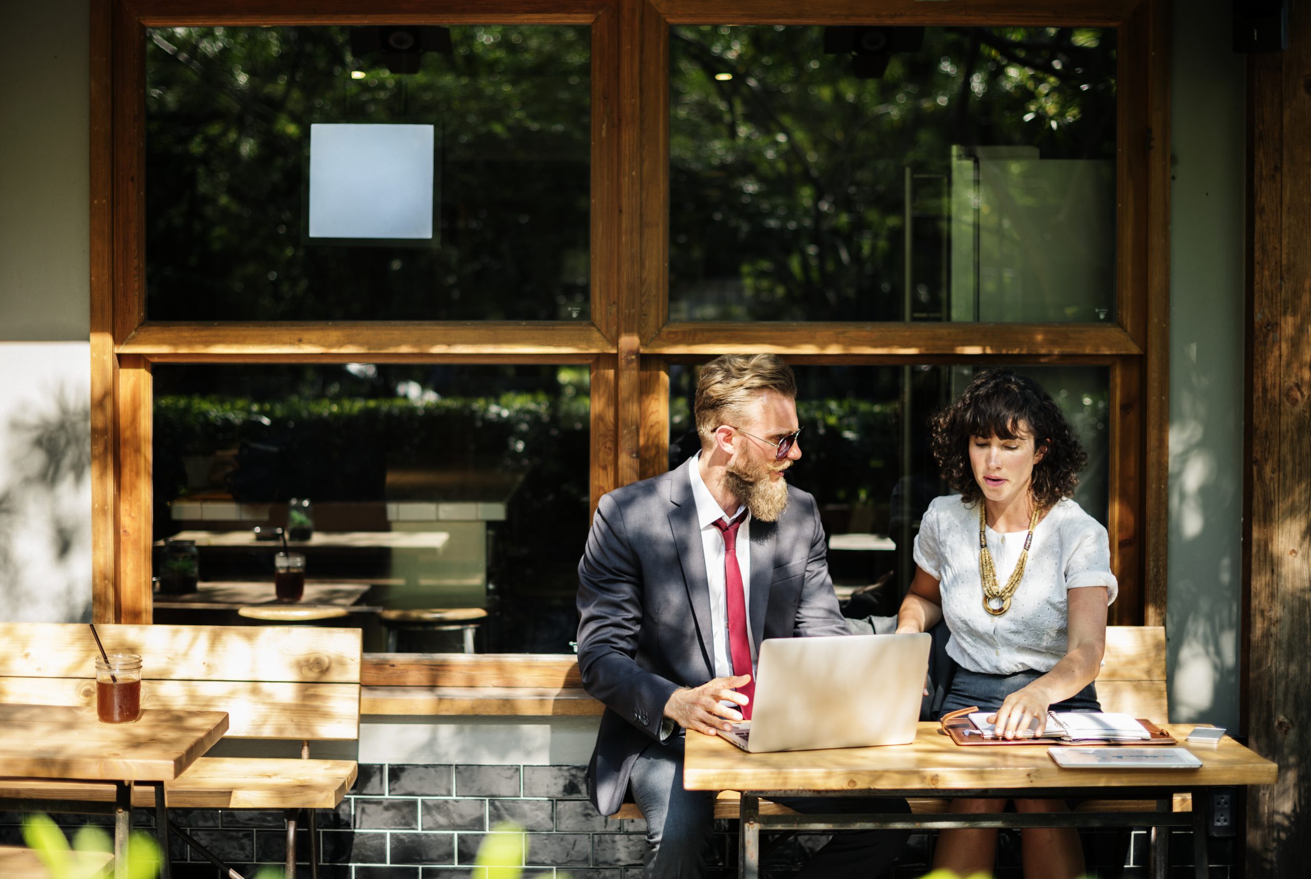 Small business owners meeting with a business attorney to discuss intellectual property strategy and brand protection in Carlsbad, California