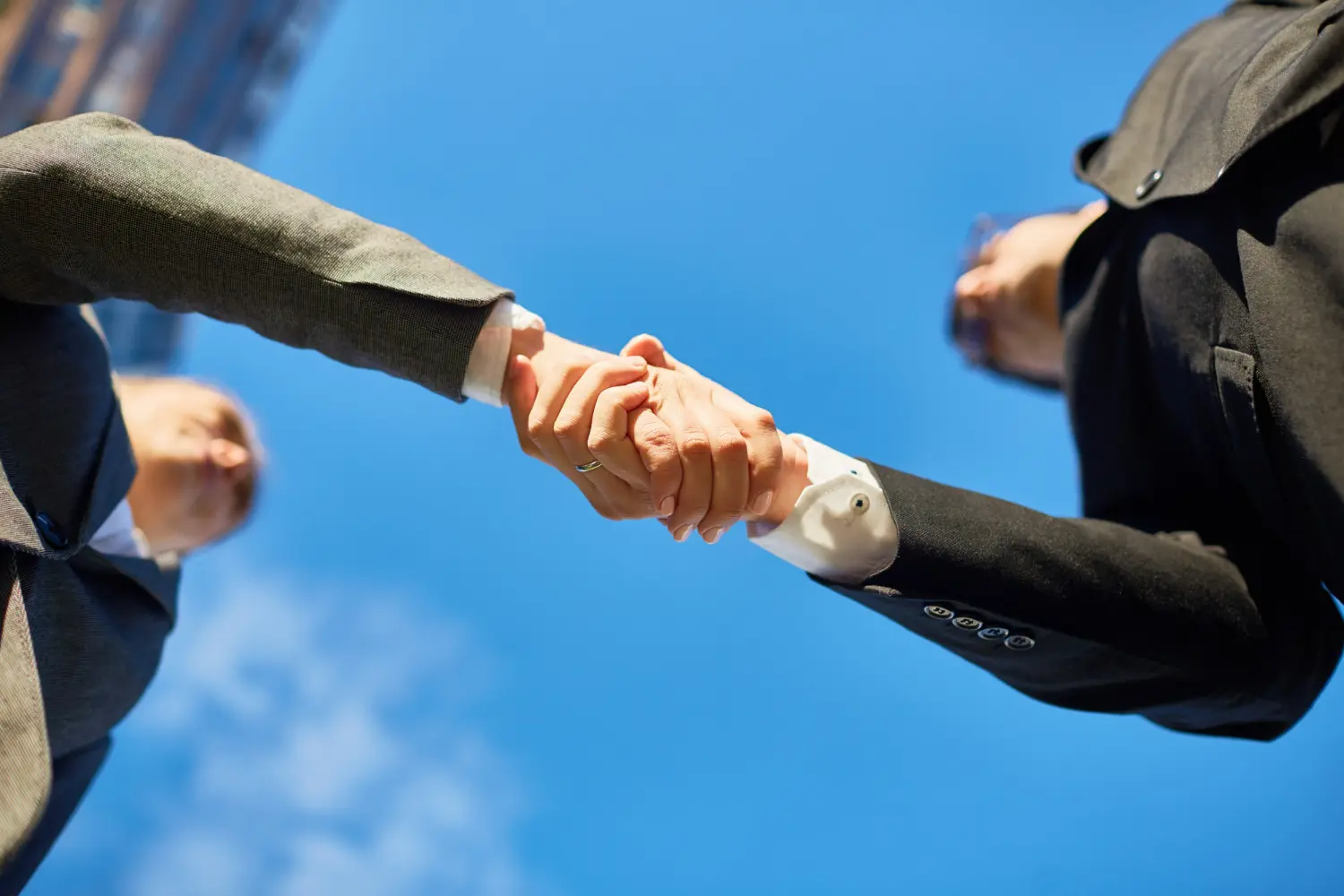 Two business professionals shaking hands, symbolizing partnership, agreement, and joint venture collaboration