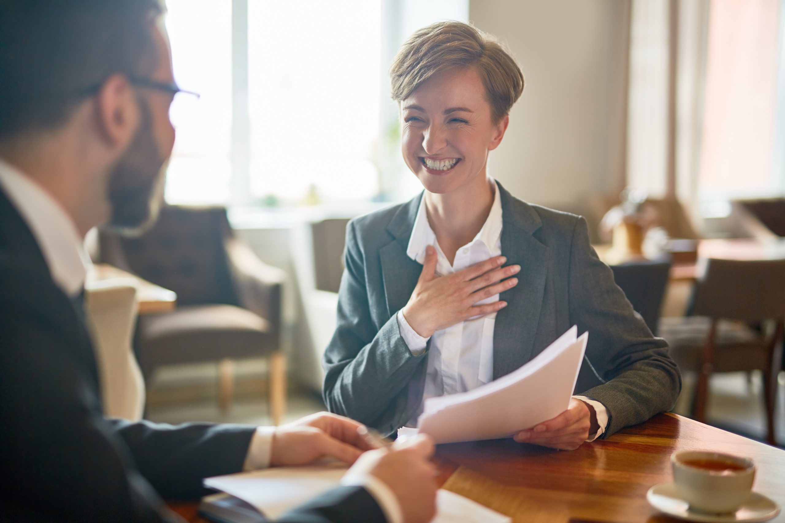 Business professionals discussing contract terms and liability provisions during a legal consultation