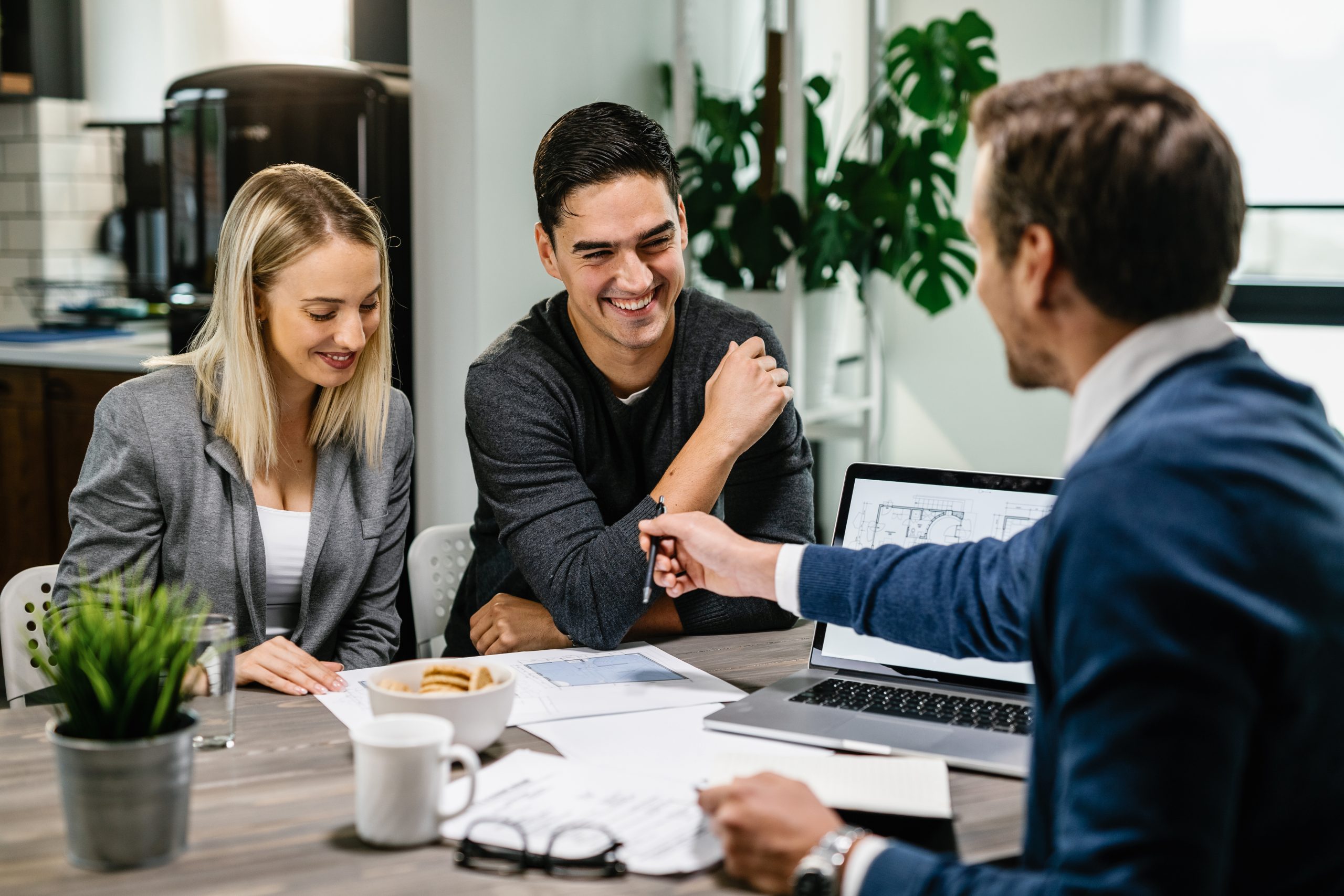 Commercial tenant meeting with a real estate professional reviewing office lease documents and property plans