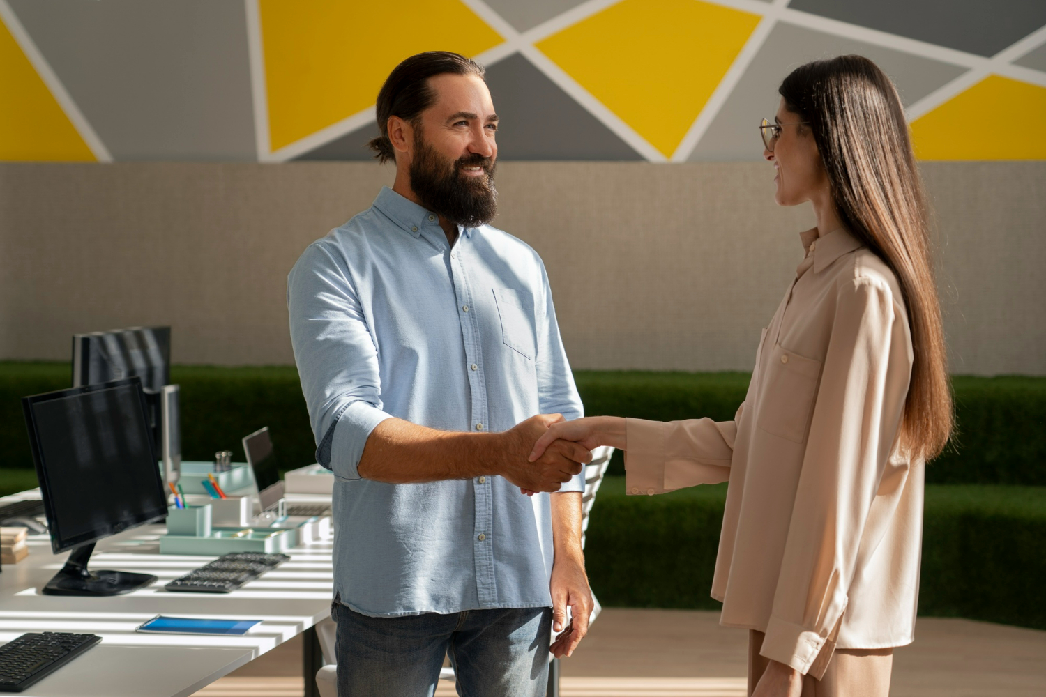 Two professionals shaking hands after discussing a business agreement, partnership, or commercial transaction