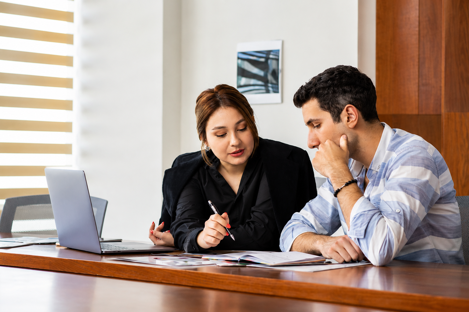 Attorney meeting with a property owner to review deed records, title history, and potential legal options for resolving an ownership or boundary dispute