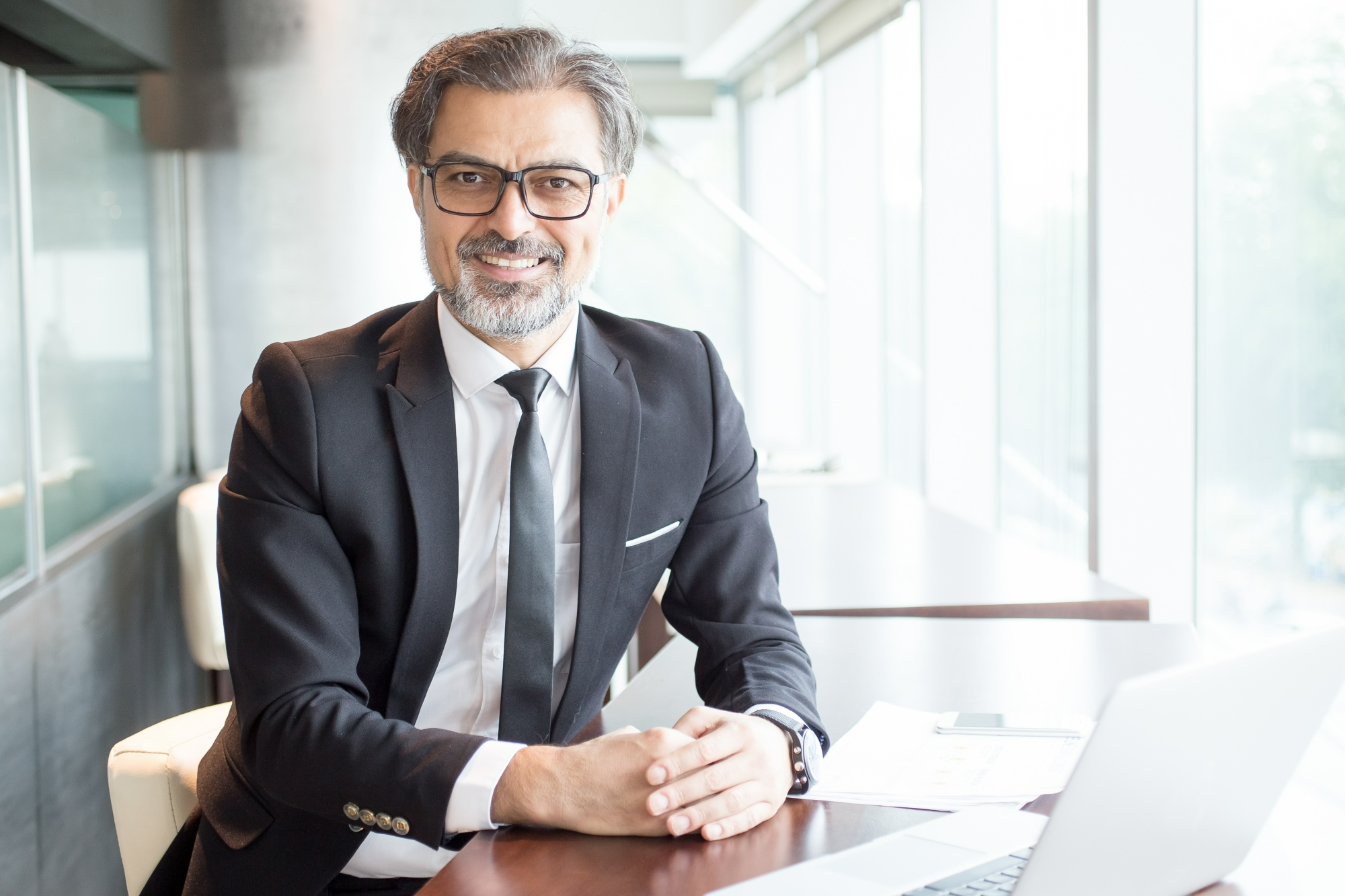 California business attorney sitting in a modern office, ready to advise business owners on formation, contracts, and legal compliance
